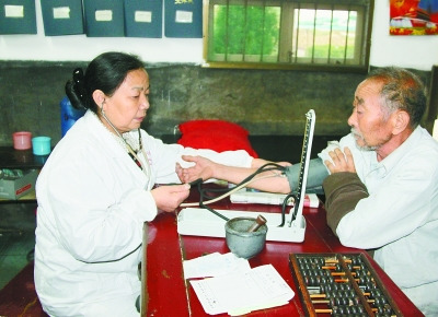 曾玉萍(左)在為患者看病。 喻無(wú)瑕 攝